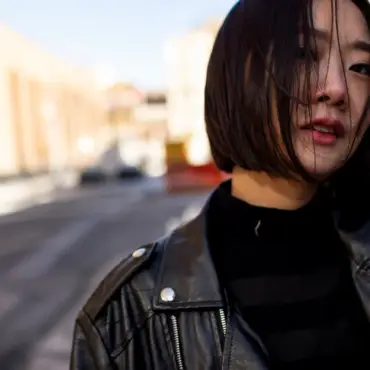 A Japanese woman wearing a black leather jacket, symbolizing the evolving cultural acceptance of womens vibrating products in Japan.