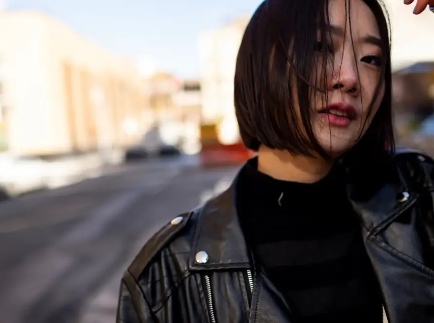 A Japanese woman wearing a black leather jacket, symbolizing the evolving cultural acceptance of womens vibrating products in Japan.