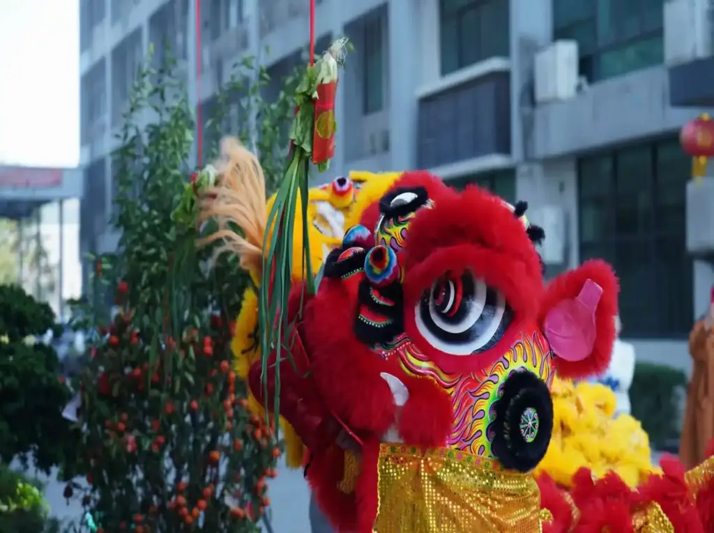 A vibrant red lion dance performed during Gaia in Love's 2024 New Year celebration, showcasing cultural tradition and the brand's dedication to empowering women through Sey toys innovation.