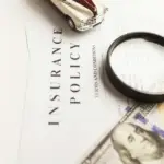 A magnifying glass, a toy car, and a $100 bill on an insurance policy document, symbolizing Gaia in Love's commitment to adhering to global adult toy safety regulations and quality standards.