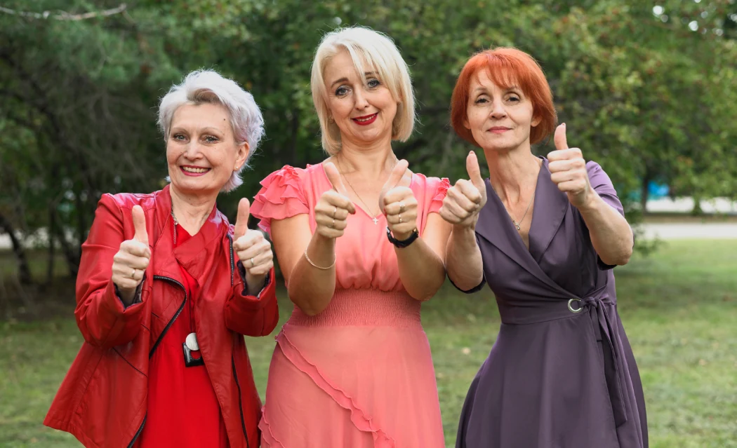 Three smiling ladies standing together