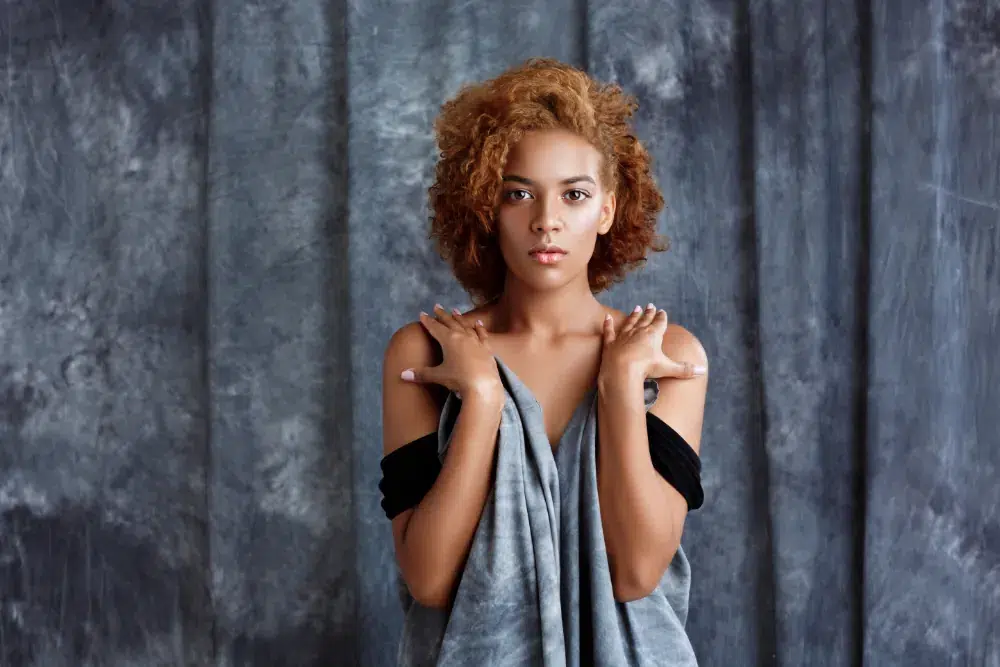 Young woman posing with a gray cloth