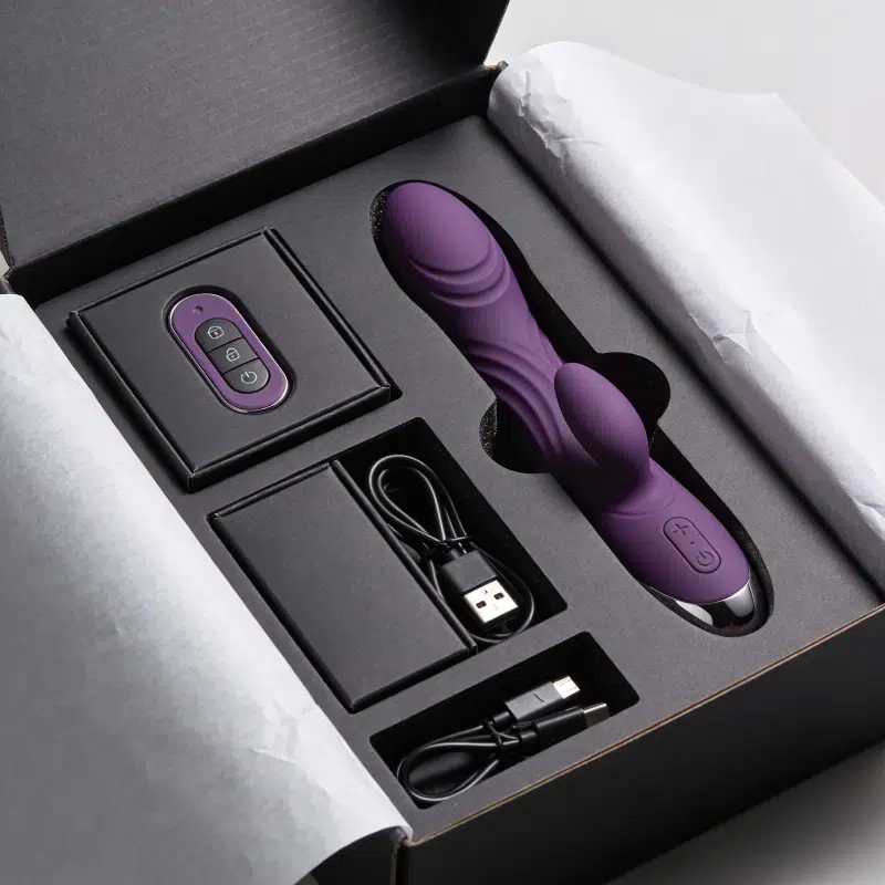 Premium sex toy gift box with organized foam insert, accessory boxes, remote control, and charging cables for a clean unboxing layout.
