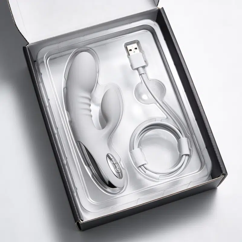 Blister tray packaging insert holding a vibrator and USB charging cable securely inside a retail box.