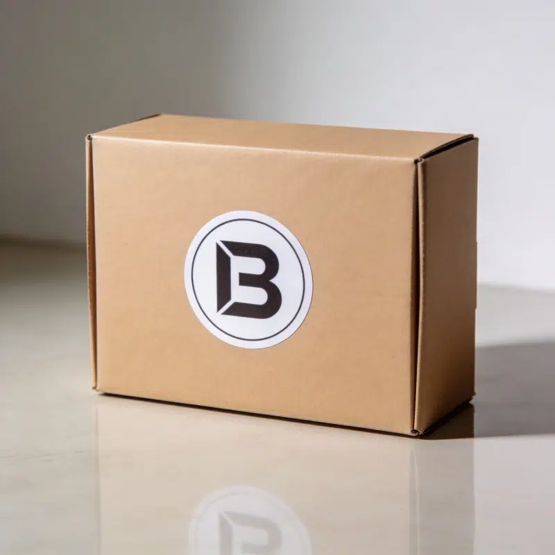 Low MOQ starter packaging with a kraft stock box and custom branded sticker label on the front.